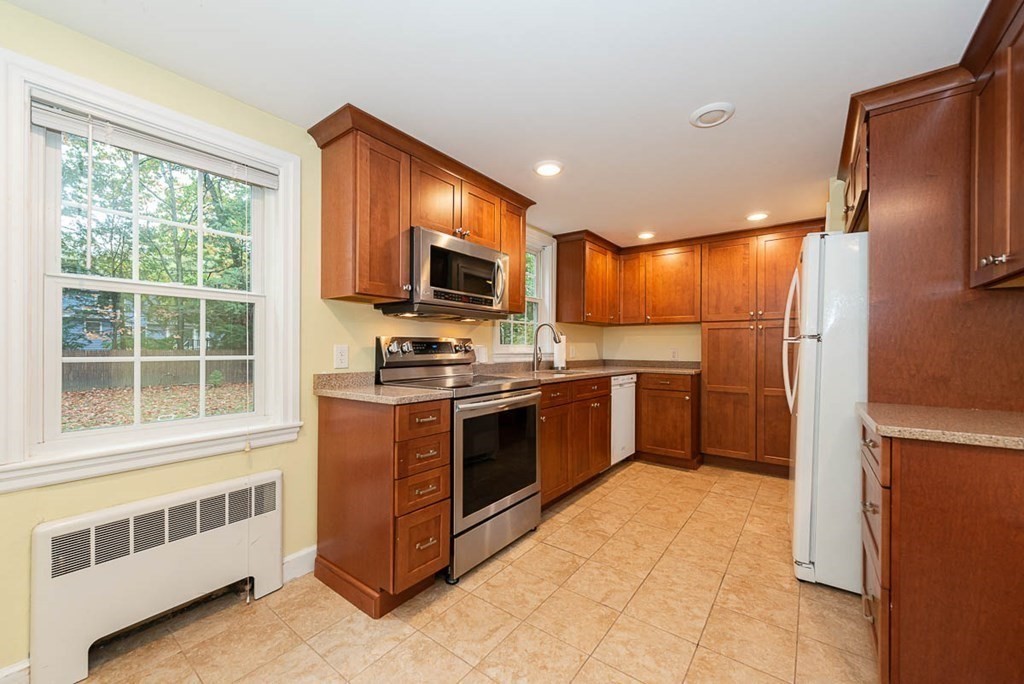 62 Spring Street Lexington, MA 02421 - Photo 14 of 32 a kitchen with stainless steel appliances a refrigerator and a stove top oven