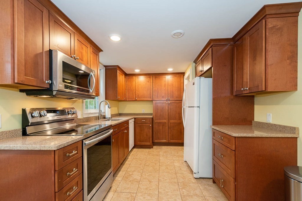 62 Spring Street Lexington, MA 02421 - Photo 16 of 32 a kitchen with stainless steel appliances granite countertop a stove a sink dishwasher and a refrigerator