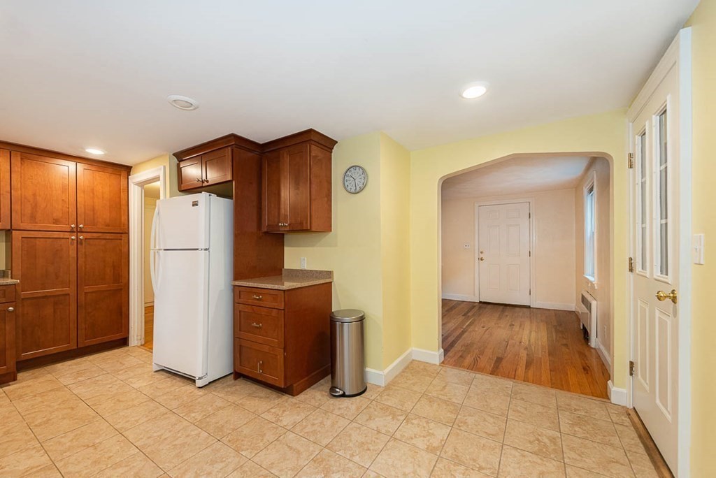 62 Spring Street Lexington, MA 02421 - Photo 17 of 32 a view of a refrigerator in kitchen and an empty room