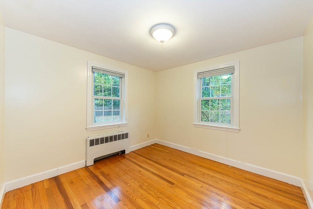 62 Spring Street Lexington, MA 02421 - Photo 18 of 32 an empty room with wooden floor and windows