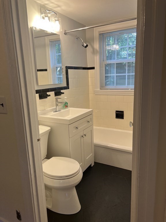 62 Spring Street Lexington, MA 02421 - Photo 20 of 32 a bathroom with a sink a toilet and shower
