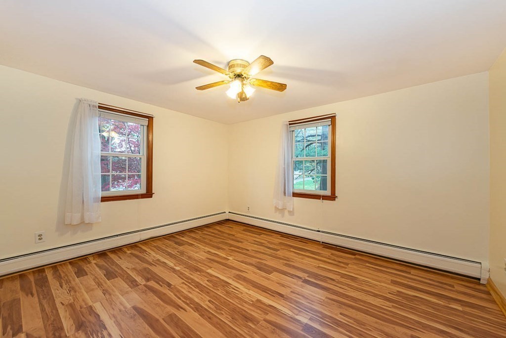 62 Spring Street Lexington, MA 02421 - Photo 21 of 32 a view of an empty room with window and wooden floor