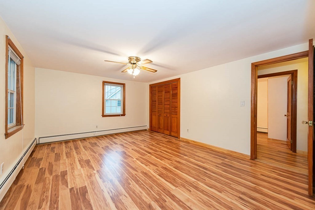 62 Spring Street Lexington, MA 02421 - Photo 23 of 32 a view of an empty room with wooden floor and a window