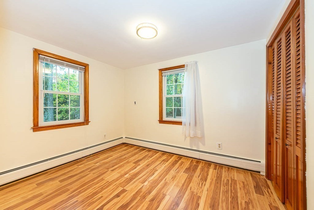 62 Spring Street Lexington, MA 02421 - Photo 25 of 32 an empty room with wooden floor and windows