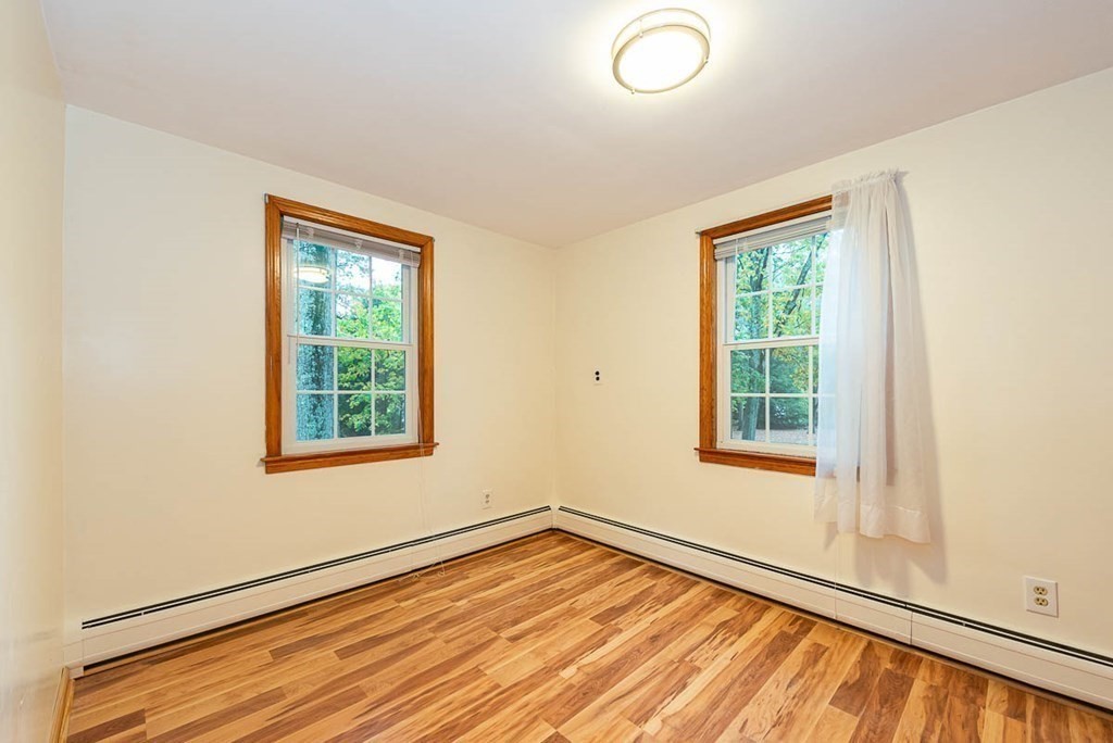 62 Spring Street Lexington, MA 02421 - Photo 26 of 32 an empty room with wooden floor and windows