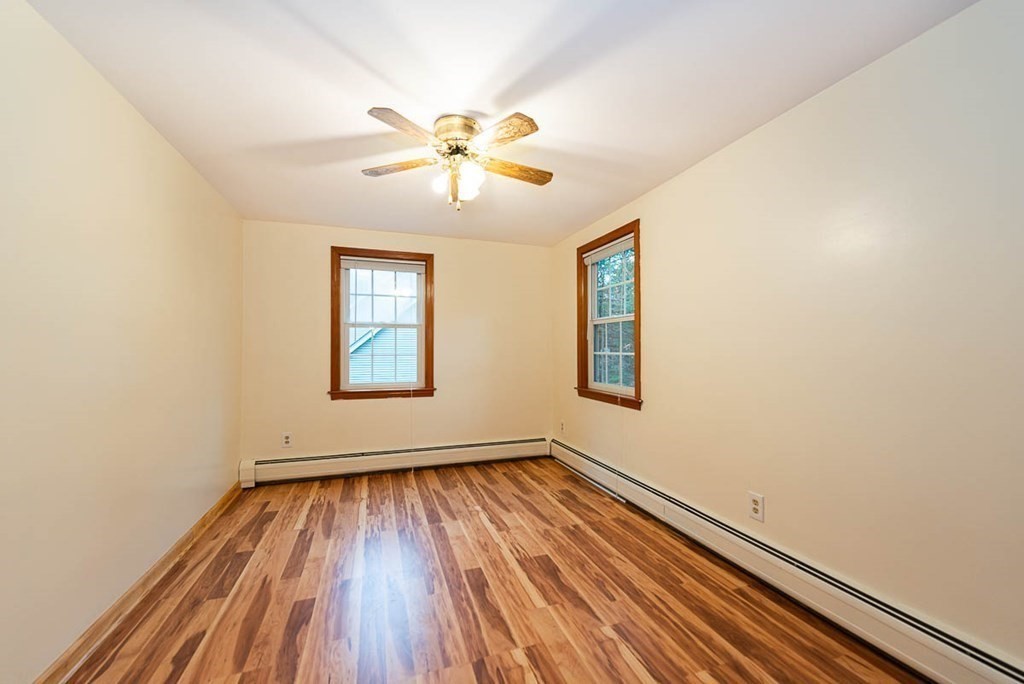 62 Spring Street Lexington, MA 02421 - Photo 28 of 32 a view of an empty room with wooden floor and a window