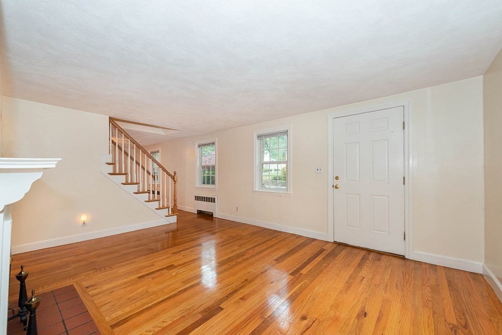 62 Spring Street Lexington, MA 02421 - Photo 5 of 32 a view of an empty room with wooden floor and a window