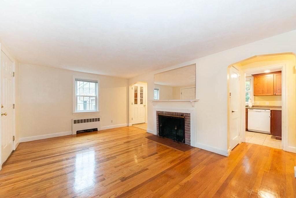 62 Spring Street Lexington, MA 02421 - Photo 7 of 32 a view of an empty room with wooden floor and a window