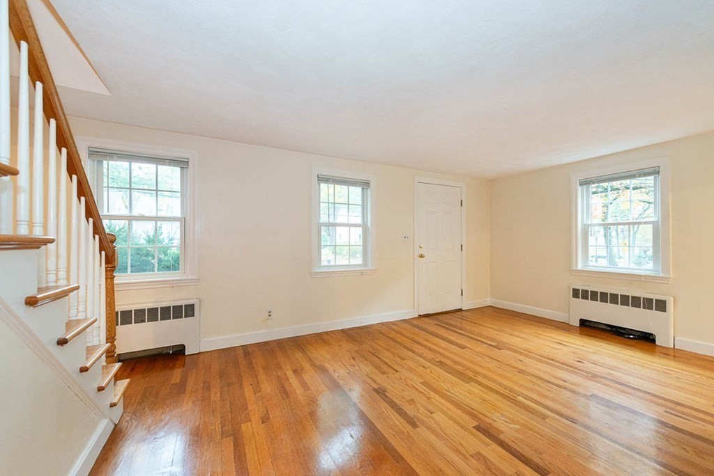 62 Spring Street Lexington, MA 02421 - Photo 8 of 32 an empty room with wooden floor and windows
