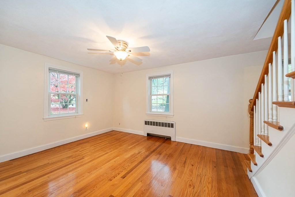 62 Spring Street Lexington, MA 02421 - Photo 9 of 32 a view of empty room with wooden floor and fan