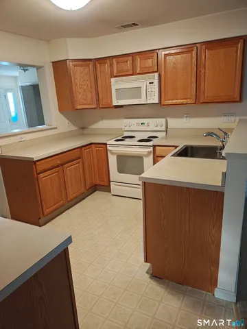 a kitchen with stainless steel appliances a stove a sink and a microwave
