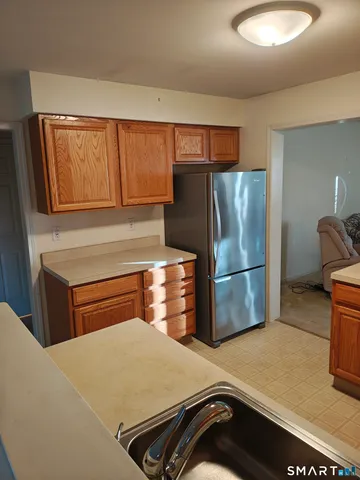 a kitchen with a refrigerator and a sink