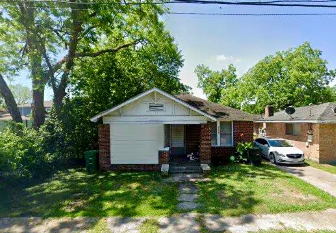 a view of house with backyard space and garden