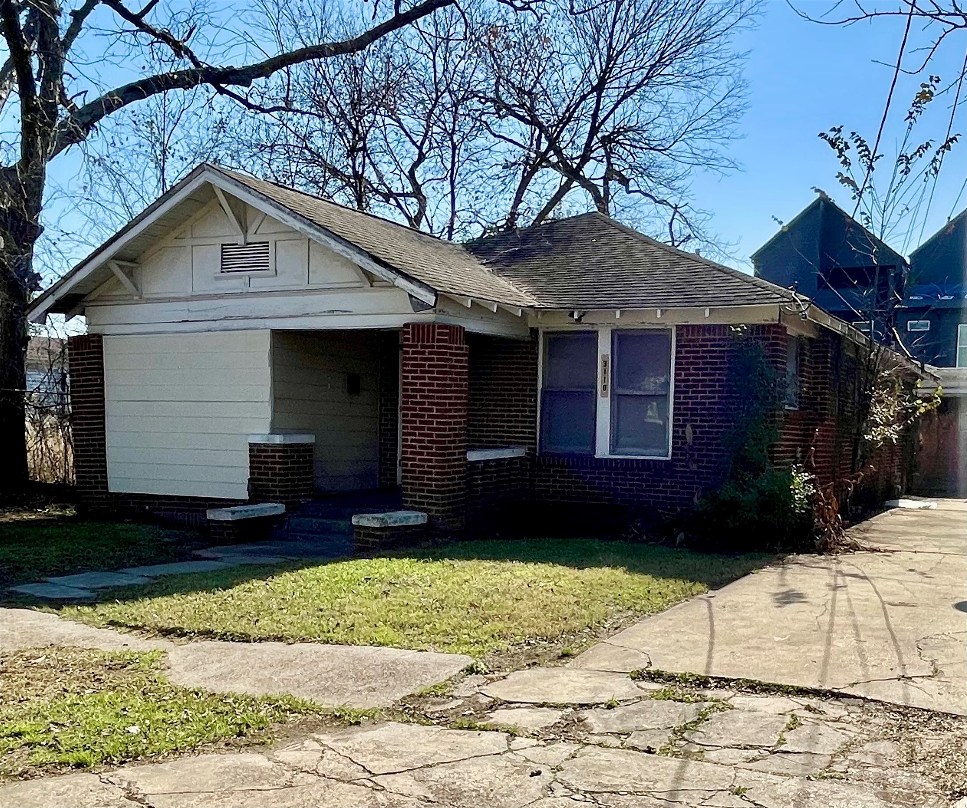 3110 Gray Street Houston, TX 77004 - Photo 2 of 14 a front view of a house with a yard and garage
