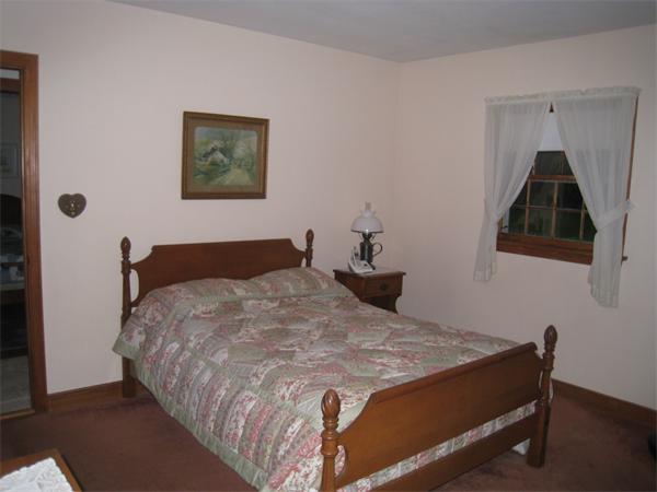 233 South Meadow Road Lancaster, MA 01523 - Photo 11 of 21 a bedroom with a bed and wall painting