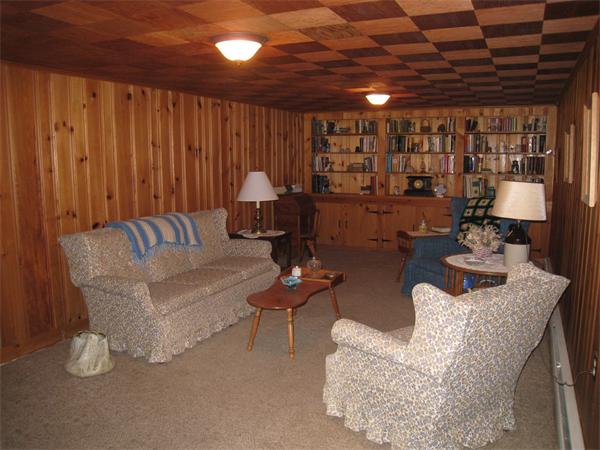 233 South Meadow Road Lancaster, MA 01523 - Photo 12 of 21 a living room with furniture and a chandelier