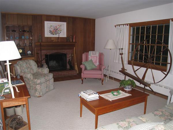 233 South Meadow Road Lancaster, MA 01523 - Photo 6 of 21 a living room with furniture a flat screen tv and a fireplace