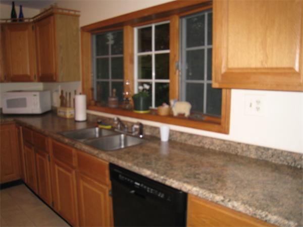 233 South Meadow Road Lancaster, MA 01523 - Photo 7 of 21 a kitchen with granite countertop a sink and a large window