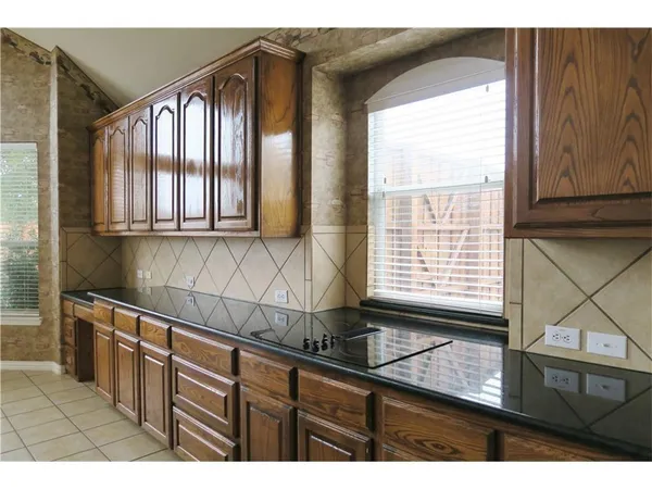 a kitchen with granite countertop a sink and a window