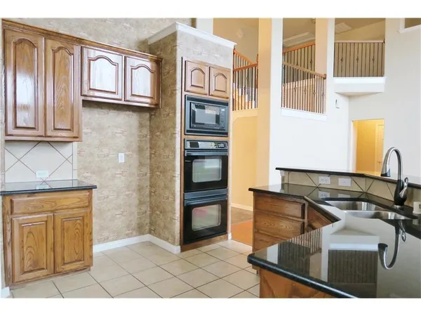 a kitchen with stainless steel appliances granite countertop a refrigerator and a stove