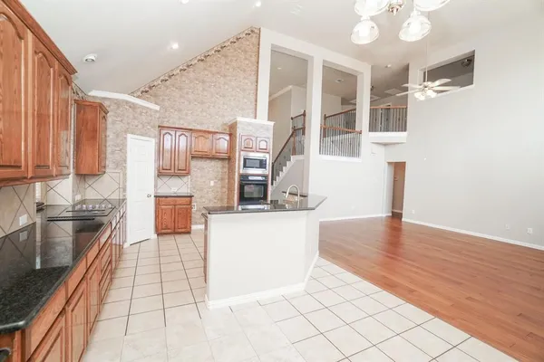 a kitchen with stainless steel appliances a refrigerator and a stove top oven