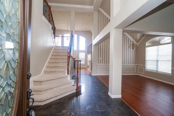 a view of entryway and hall with wooden floor