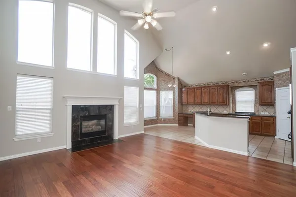a view of a kitchen with a sink a microwave and cabinets