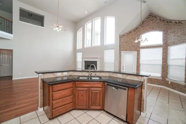 a kitchen with granite countertop a sink stove and cabinets
