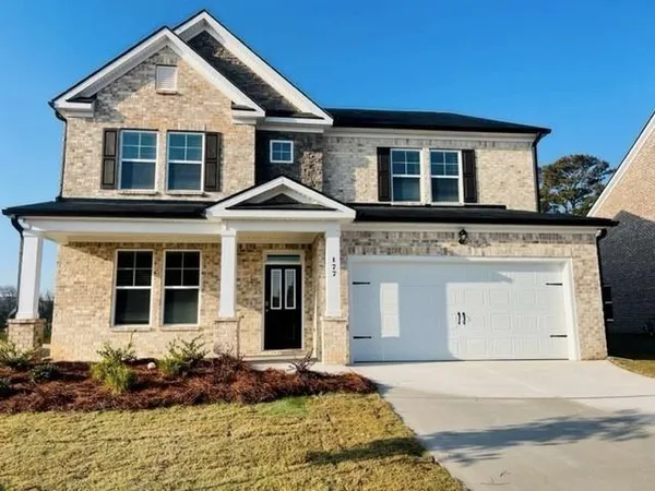 a front view of a house with a yard