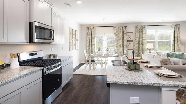 a kitchen with granite countertop a stove and a sink