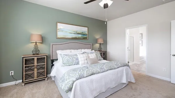 a bedroom with a bed and a lamp