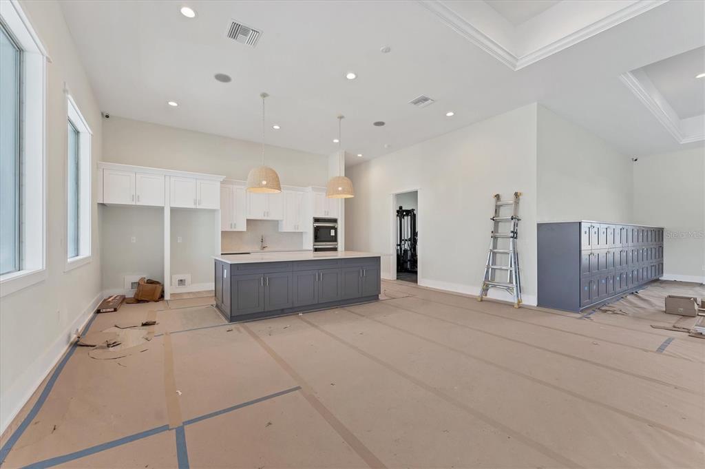 9001 Gasparilla Road, Unit 6 Rotonda West, FL 33947 - Photo 28 of 79 a large white kitchen with kitchen island a sink stainless steel appliances and cabinets