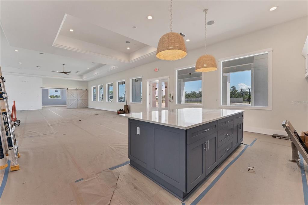 9001 Gasparilla Road, Unit 6 Rotonda West, FL 33947 - Photo 29 of 79 a spacious bathroom with a granite countertop sink and a large mirror