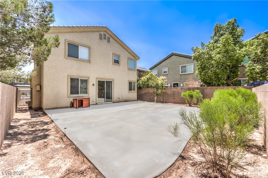 585 Foster Springs Road Las Vegas, NV 89148 - Photo 36 of 39 Back of property featuring a fenced backyard, stucco siding, and a patio