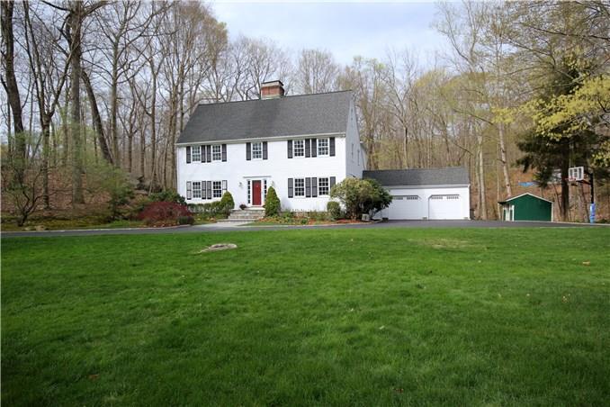 126 Pheasant Run Road Wilton, CT 06897 - Photo 1 of 1 a front view of a house with garden and trees