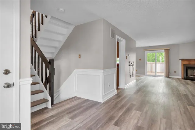 a view of entryway with wooden floor and stairs