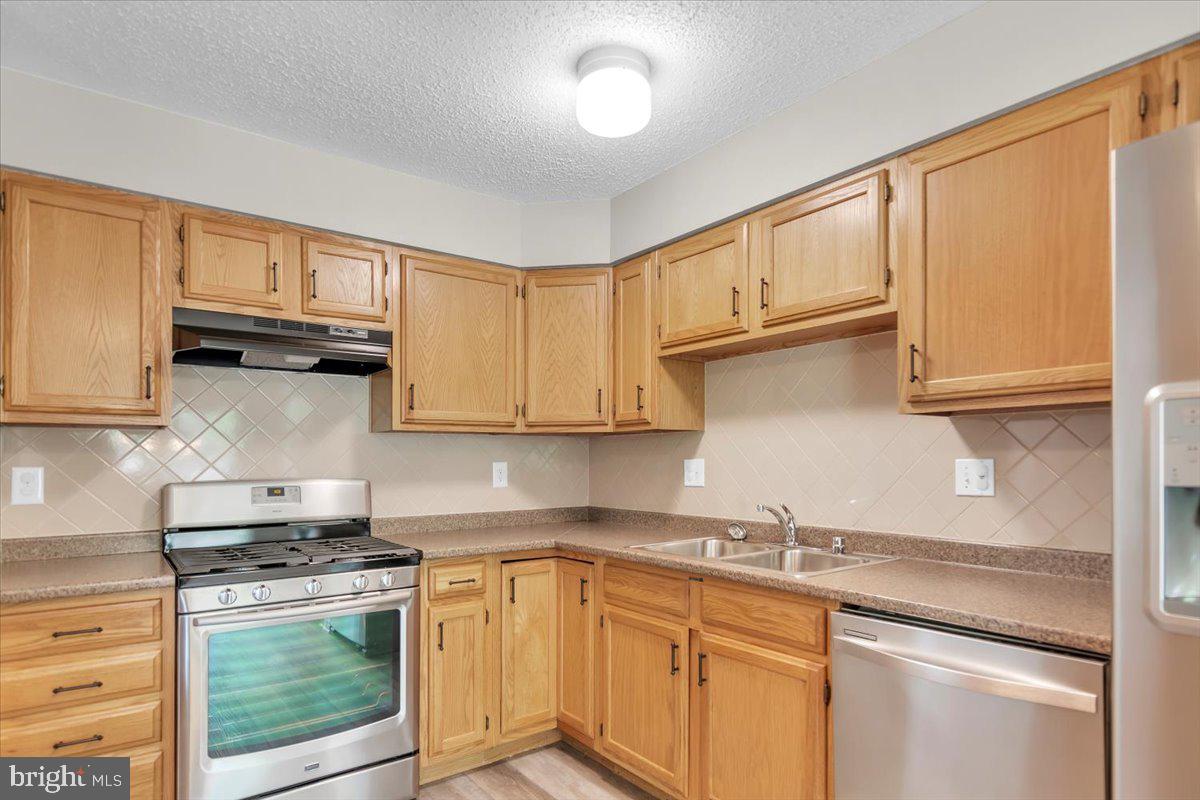 518 Demoss Court Glassboro, NJ 08028 - Photo 5 of 29 a kitchen with stainless steel appliances granite countertop a sink stove and cabinets