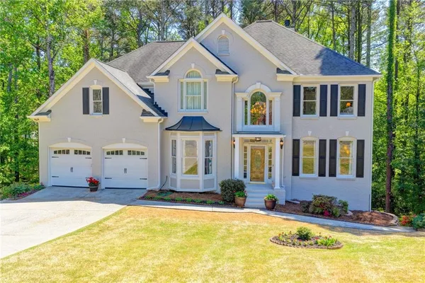 a front view of a house with a yard