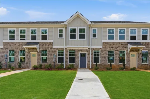 a front view of a house with a yard