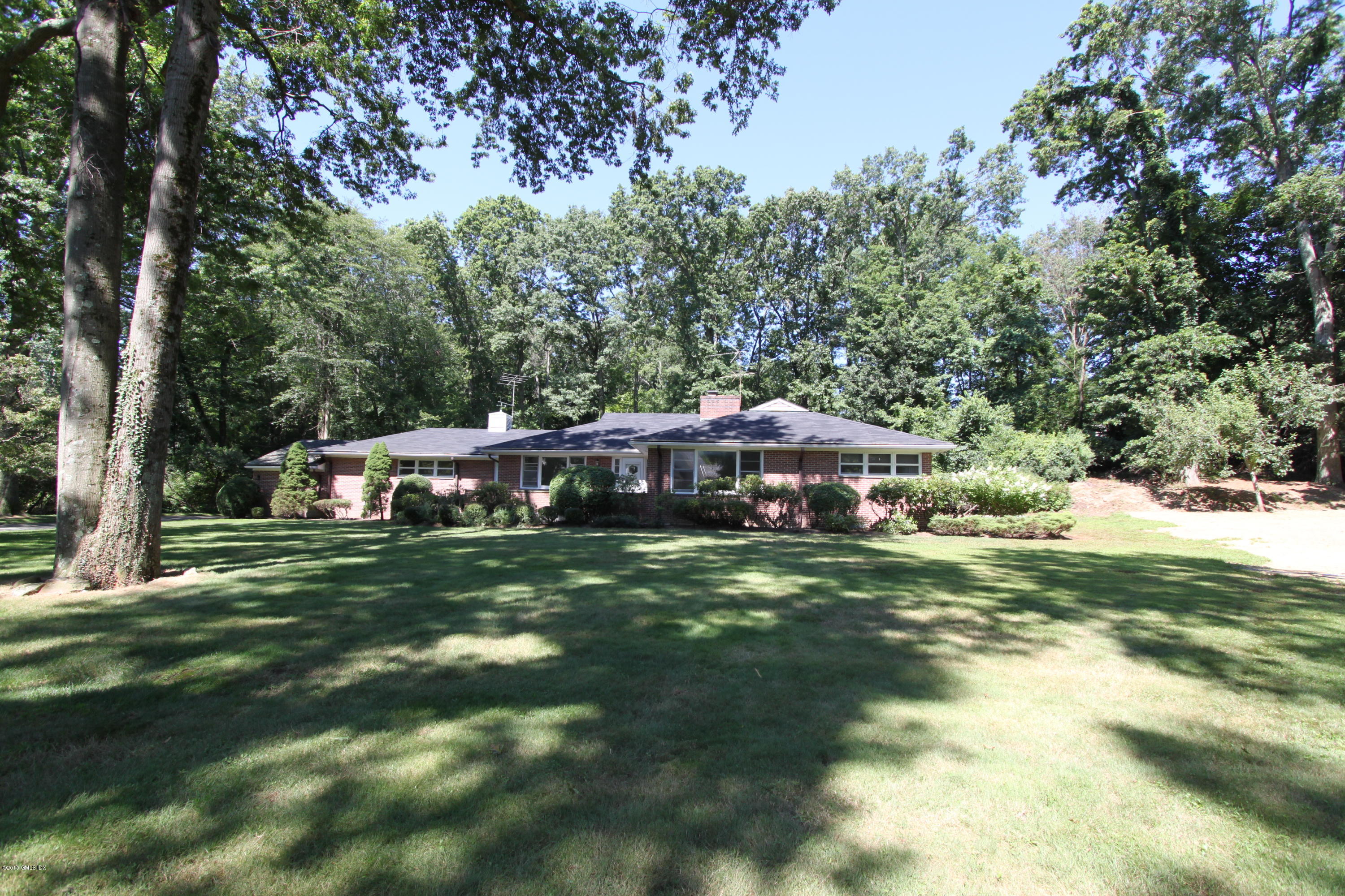 26 Beechcroft Road Greenwich, CT 06830 - Photo 1 of 6 a front view of a house with a garden