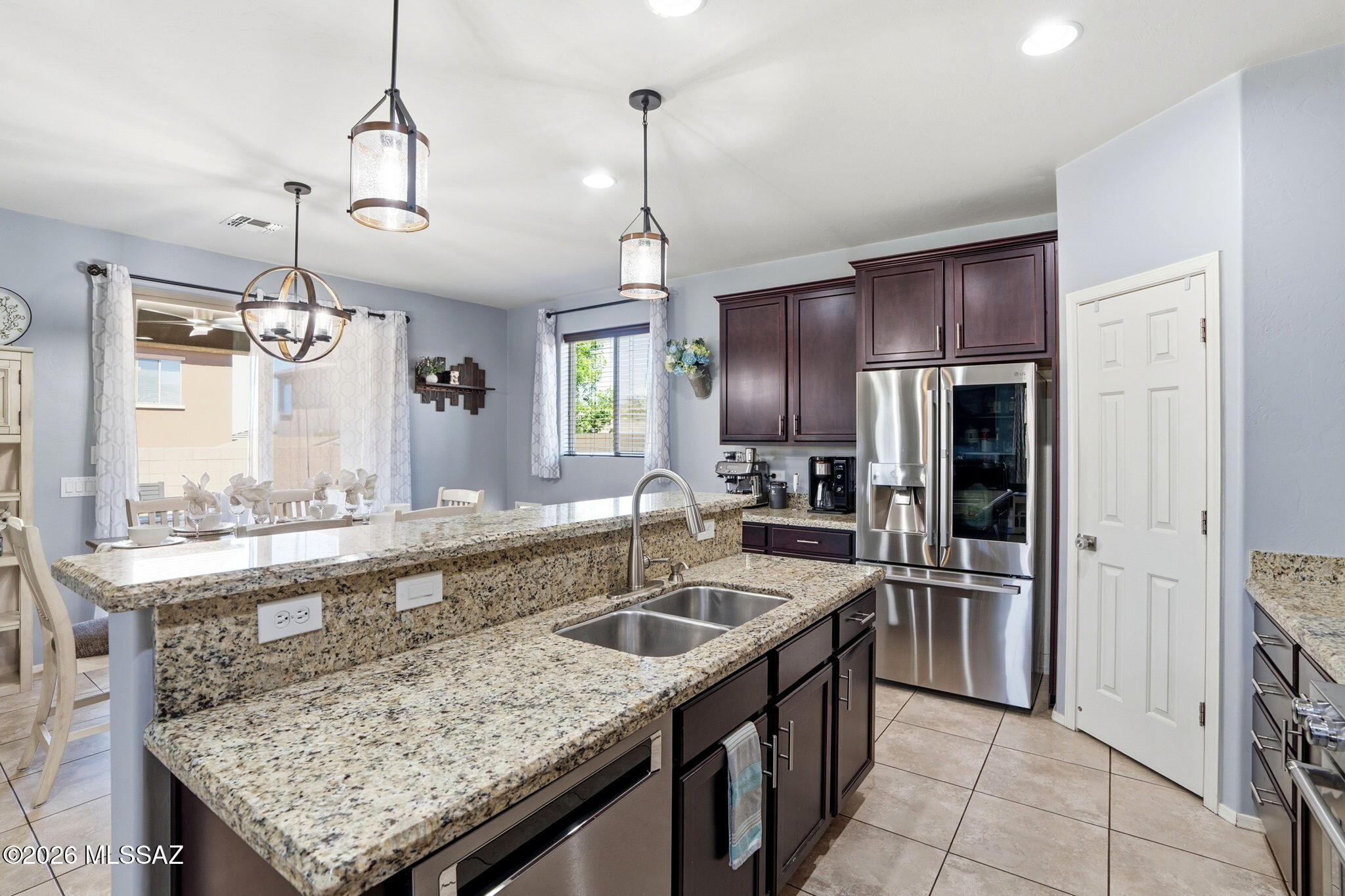 211 East Refuge Loop Vail, AZ 85641 - Photo 11 of 48 a kitchen with stainless steel appliances granite countertop a sink stove and refrigerator