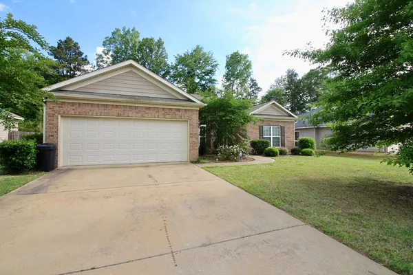 a front view of house with yard and green space