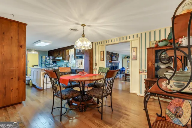 a view of a dining room with furniture window and wooden floor