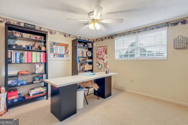 a room with furniture a bookshelf and a window