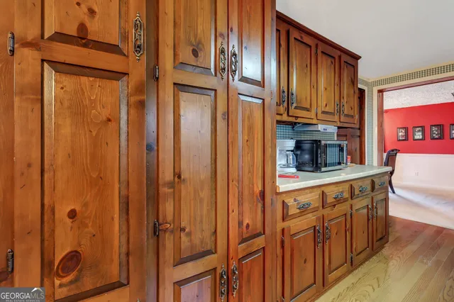 a kitchen with stainless steel appliances granite countertop cabinets and a refrigerator