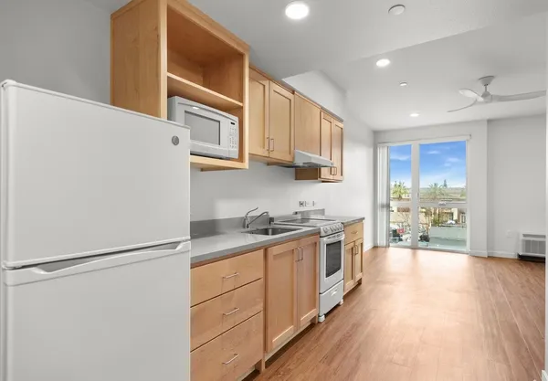 a kitchen with stainless steel appliances a refrigerator sink and cabinets