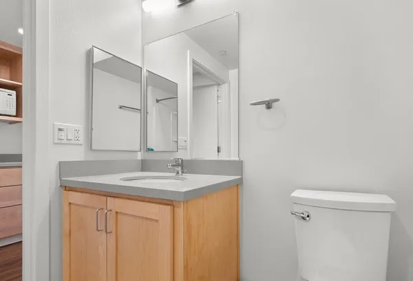 a bathroom with a granite countertop sink and a mirror