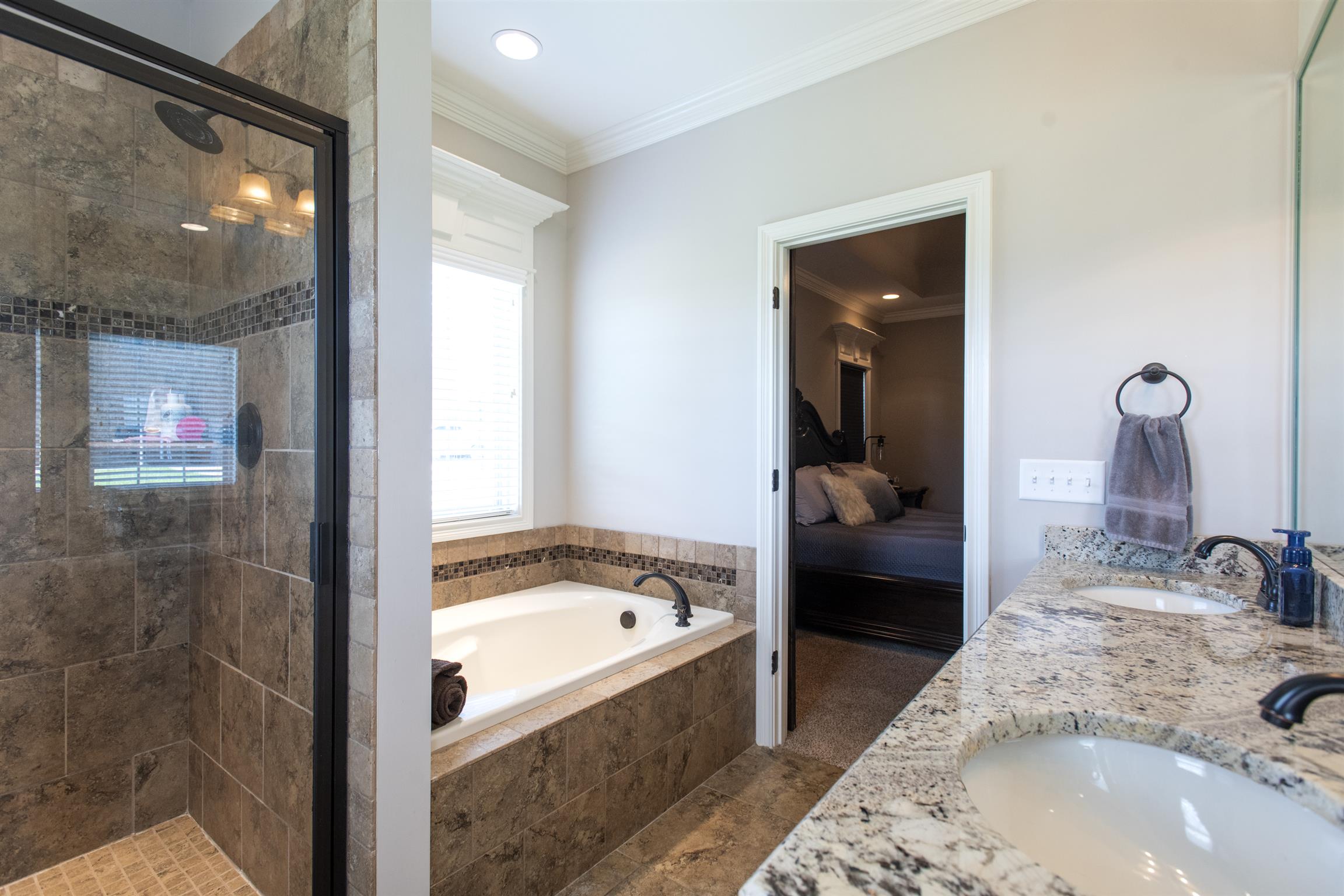 580 Academy Road Lebanon, TN 37087 - Photo 20 of 30 a en suite bathroom with a tub sink and mirror