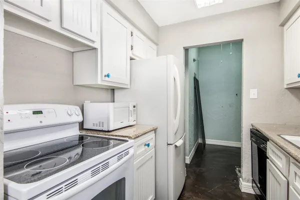 a kitchen with a sink stove and refrigerator