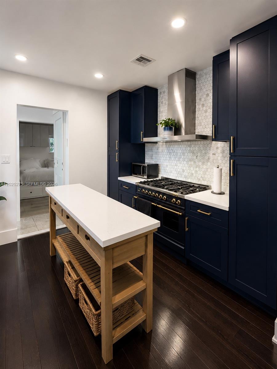 1329 Tyler Street Hollywood, FL 33019 - Photo 3 of 10 a kitchen that has a stove and a wooden floor